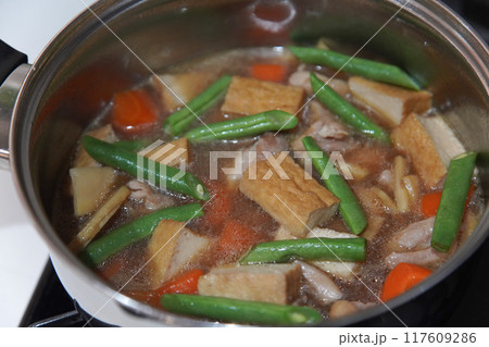 鶏もも肉と筍と厚揚げの煮物を作る様子 117609286