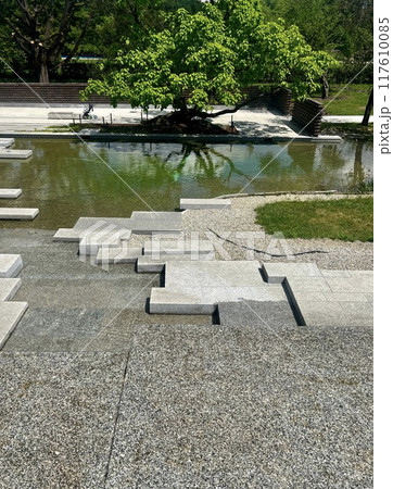 Stone steps in the park on a sunny summer day. Japanese garden at Silesian park, Chorzow, Poland Stone steps in the park on a sunny summer day. Japanese garden at Silesian park, Chorzow, Poland 117610085