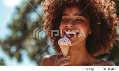 Woman enjoying ice cream on a sunny day. Woman enjoying ice cream on a sunny day. 117610367