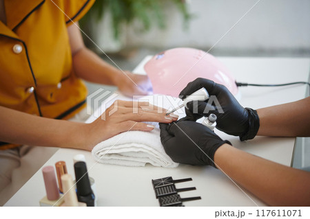 Receiving Professional Manicure in Modern Salon Receiving Professional Manicure in Modern Salon 117611071