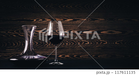 Decanter and glass with red wine on wooden rustic background 117611135
