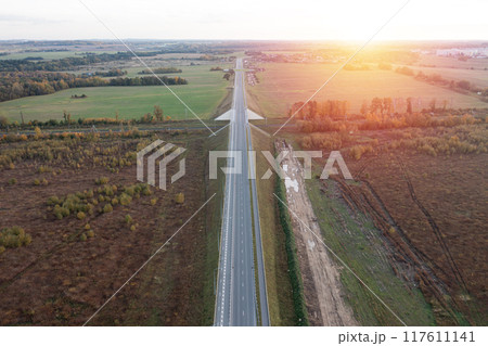 Railway and asphalt road through autumn forest. Aerial view 117611141