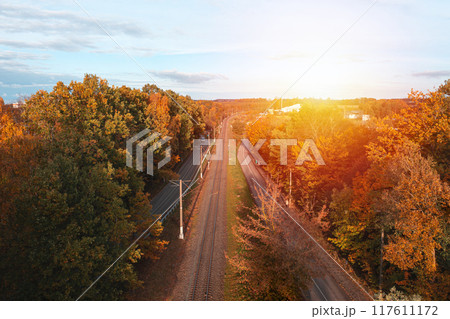 Railway through autumn forest. Aerial view from drone Railway through autumn forest. Aerial view from drone 117611172