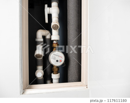 Water meter in box with pipes built into the wall . Water consumption measuring device Water meter in box with pipes built into the wall . Water consumption measuring device 117611180