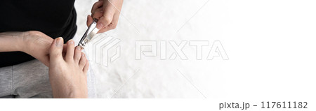 Cut long nails on male foot.  Making pedicure procedure Cut long nails on male foot.  Making pedicure procedure 117611182