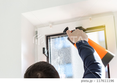 Installation of tinted film. Ultraviolet and energy afficiency concept. 117611196