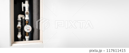 Water meter in box with pipes built into the wall . Water consumption measuring device. Long banner 117611415