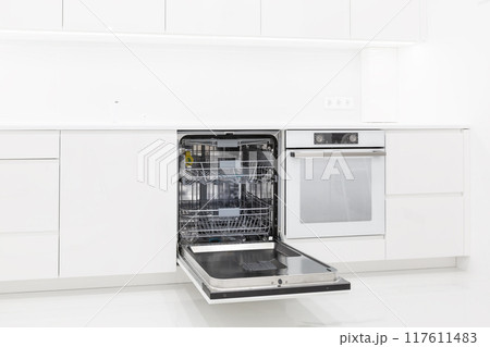 Washing machine with opened door at modern kitchen interior 117611483