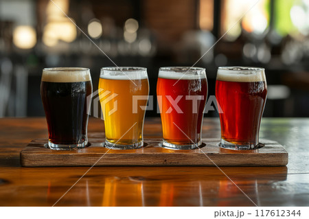 Different craft beers standing on bar top in brewery 117612344