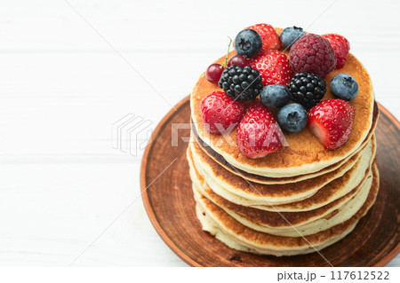 Stack of homemade american pancakes with berries . Top view 117612522