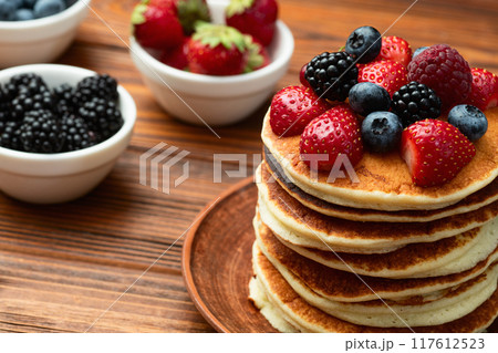 Stack of homemade american pancakes with berries . Top view 117612523