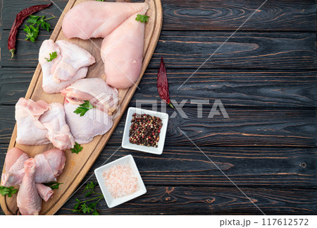 Raw mixed chicken meat parts  for cooking on rustic background 117612572