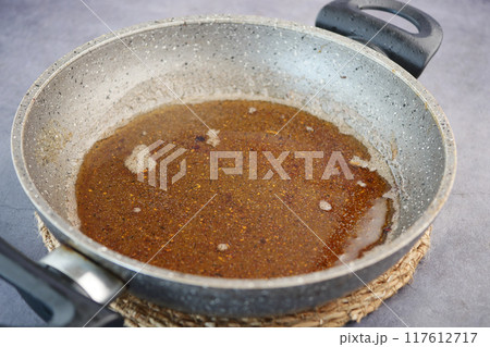 Used vegetable oil in a plate . 117612717