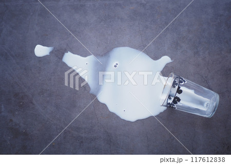 Spilled white milk on a black background  117612838
