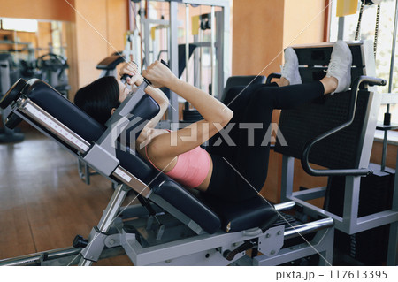 The Routine Exercise Of A Woman In The Gym The Routine Exercise Of A Woman In The Gym 117613395