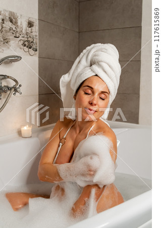 Pregnant Woman in Bath with Towel and Candles 117615869