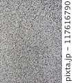 close-up texture shot of a rough, grey surface reminiscent of concrete or stucco. The granular quality and uneven shade variation make it suitable for backgrounds, graphic design 117616790