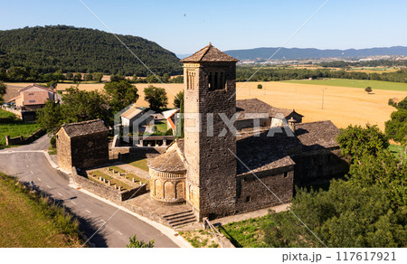 Aerial view of bell tower and apse of the Mozarab Pre-Romanesque or Romanesque Church of San Pedro de Larrede in the Serrablo Region. Spain 117617921