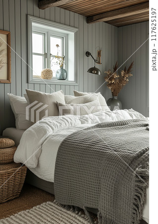 Cozy bedroom with a bed, a window, and a grey blanket 117625197