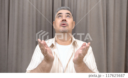 Man Looking Up and Pleading to the Sky Man Looking Up and Pleading to the Sky 117625687