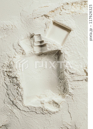Imprint of beauty product bottle on surface of sand. Perfume advertising concept 117626325