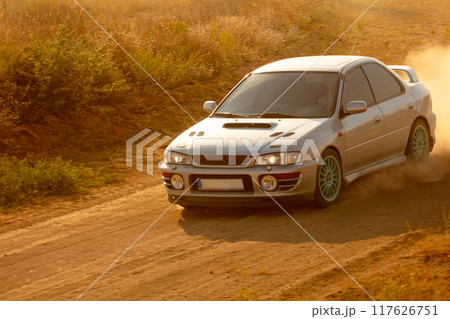 Car on Dirt Road During Sunset 117626751