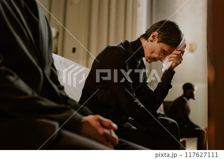 Senior woman dressed in black clothes crying and holding white handkerchief to wipe her tears Senior woman dressed in black clothes crying and holding white handkerchief to wipe her tears 117627111