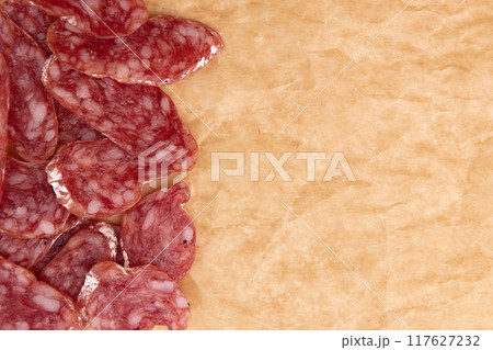 slices of salami on parchment paper 117627232