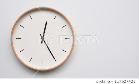 Minimalist wooden Wall Clock on White Wooden Surface with Space for Text. Time Set at 00.25/12.25 Minimalist wooden Wall Clock on White Wooden Surface with Space for Text. Time Set at 00.25/12.25 117627423