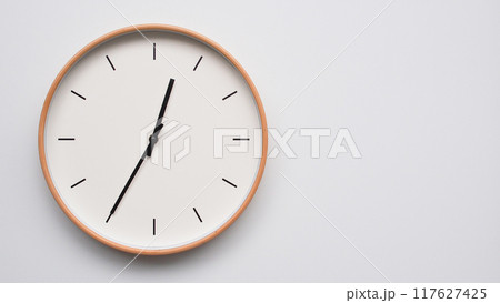 Minimalist wooden Wall Clock on White Wooden Surface with Space for Text. Time Set at 00.35/12.35 Minimalist wooden Wall Clock on White Wooden Surface with Space for Text. Time Set at 00.35/12.35 117627425