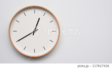 Minimalist wooden Wall Clock on White Wooden Surface with Space for Text. Time Set at 00.40/12.40 Minimalist wooden Wall Clock on White Wooden Surface with Space for Text. Time Set at 00.40/12.40 117627426