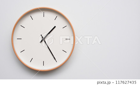 Minimalist wooden Wall Clock on White Wooden Surface with Space for Text. Time Set at 13.25/01.25 117627435