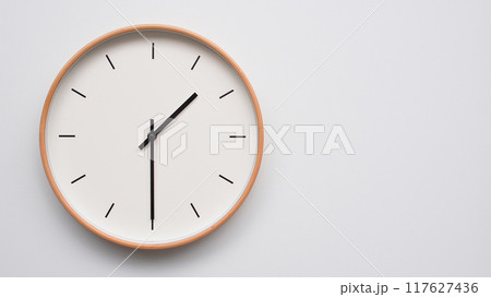 Minimalist wooden Wall Clock on White Wooden Surface with Space for Text. Time Set at 13.30/01.30 117627436