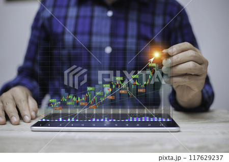 Display stock market charts. Business hand working with stock market investment use tablet. Investment growth The growing power of the compound interest concept. success wealth stock investment. 117629237