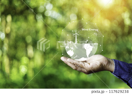 Hand holding with  green energy, Wind energy system icon on blur green leaf. Wind energy for eco car. carbon neutral and green natural background  with energy icon around it. Net zero 2050.. 117629238