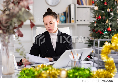 Woman manager working at computer during christmas holidays 117630061