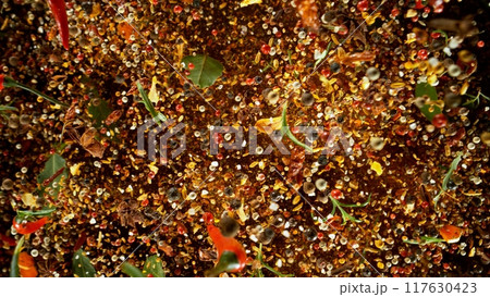 Freeze Motion Shot of Flying Mix Spices . Isolated on Black Background Freeze Motion Shot of Flying Mix Spices . Isolated on Black Background 117630423