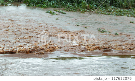 An image of thick red floodwater waves. 117632079
