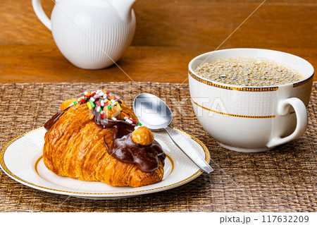 Croissant garnished with chocolate and rainbow sprinkles. Croissant garnished with chocolate and rainbow sprinkles. 117632209