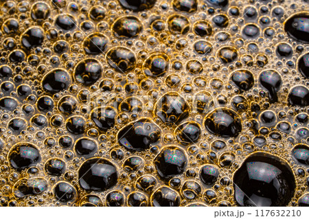 Air bubbles on the surface of hot black coffee. Air bubbles on the surface of hot black coffee. 117632210