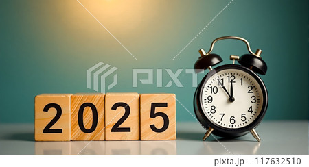New Year Eve 2025 concept featuring midnight alarm clock and Happy New Year message above wooden block digits on light blue backdrop, holiday cards and seasonal promotional materials 117632510