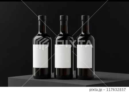 Three bottles of wine with white labels sit on a black surface, mockup for product branding Three bottles of wine with white labels sit on a black surface, mockup for product branding 117632837