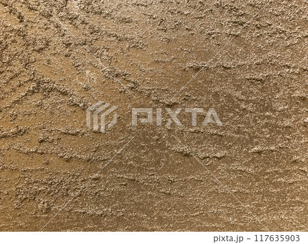 Texture of artistic plaster bronze colors. Abstract art stucco brown background with pattern, macro. 117635903