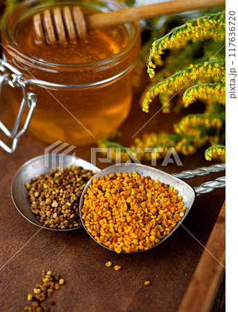 Bee honey and a wooden spoon. Sweet food. Bee honey and a wooden spoon. Sweet food. 117636720