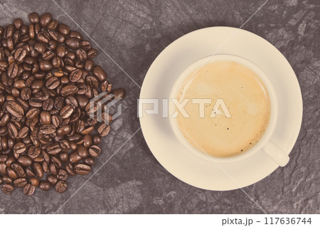 Roasted fragrant coffee grains and coffee with milk. Vintage photo 117636744