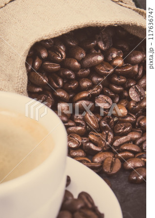 Coffee in cup and roasted dark coffee beans in bag Coffee in cup and roasted dark coffee beans in bag 117636747