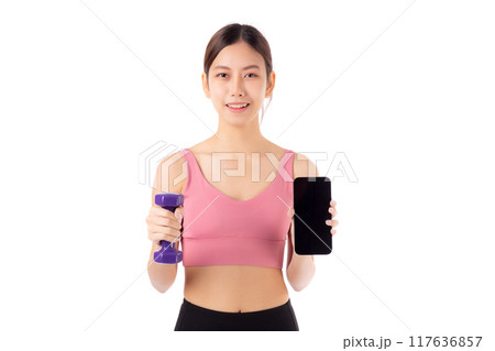 Portrait young asian woman lifting dumbbell and showing smartphone isolated. 117636857