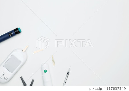 Diabetes concept with glucometer, syringe pen with insulin, blood test strips. Concept of worldwide diabetes awareness. Top view. Copy space 117637349