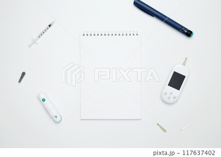 Diabetes concept with glucometer, syringe pen with insulin, blood test strips. Concept of worldwide diabetes awareness. Top view. Copy space Diabetes concept with glucometer, syringe pen with insulin, blood test strips. Concept of worldwide diabetes awareness. Top view. Copy space 117637402