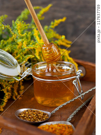 Bee honey and a wooden spoon. Sweet food. Bee honey and a wooden spoon. Sweet food. 117637789